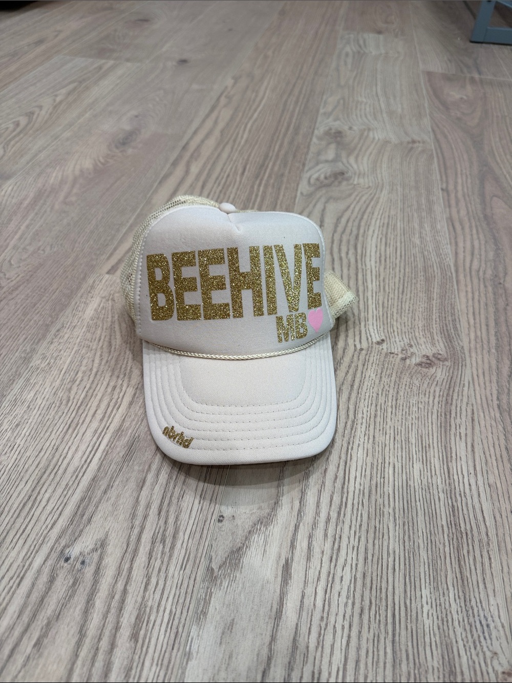 Beehive Cream Trucker Cap with Gold Glitter Logo